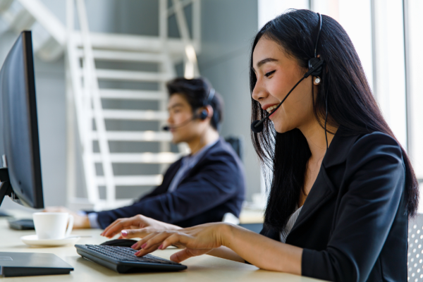 Smiling IT support agent with headset providing managed services for Sydney businesses