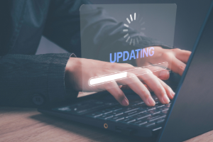 Close-up of person updating Windows laptop with on-screen progress bar