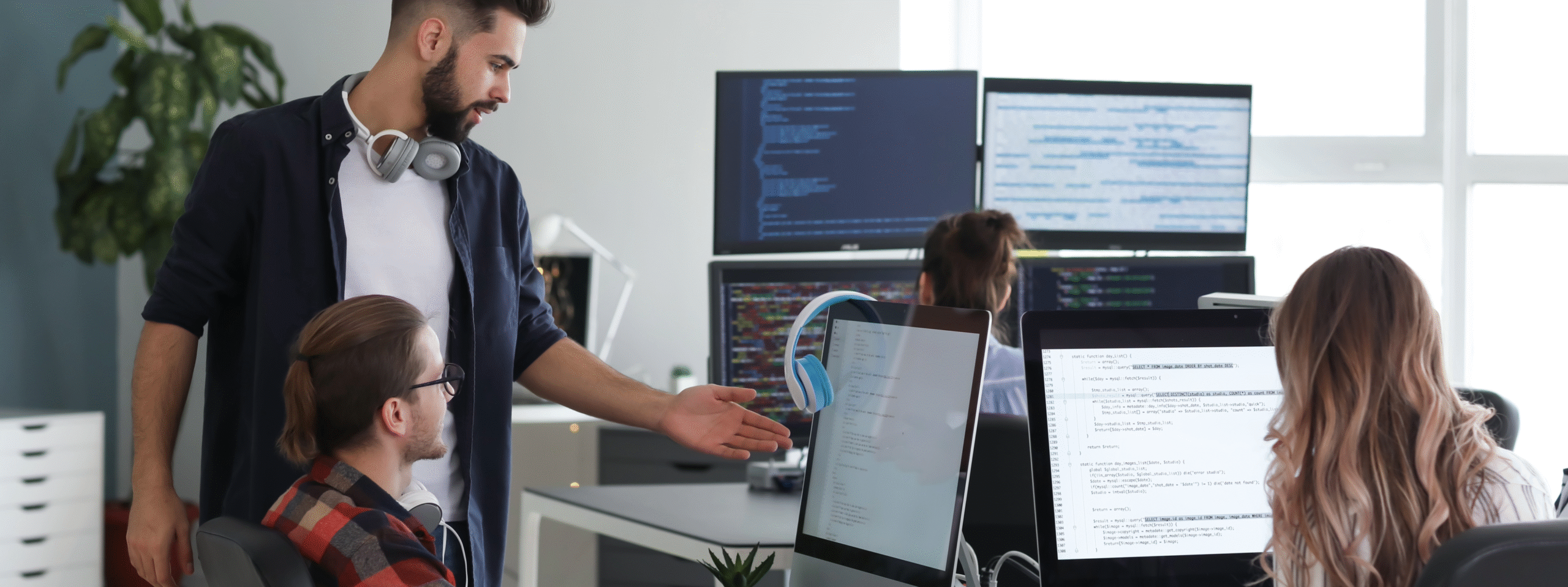 IT professionals collaborating on code in a modern tech workspace