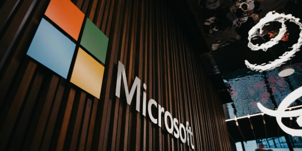 Microsoft logo on a modern office building, representing Microsoft 365 cloud services.