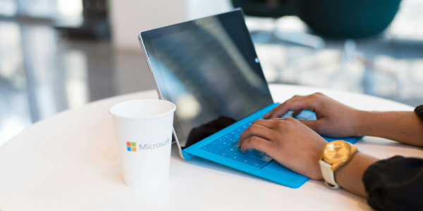 Person working on a Microsoft Surface laptop with Microsoft 365 tools, symbolising productivity and collaboration.