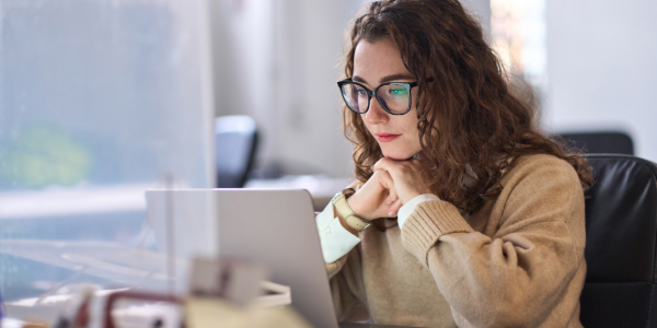 Female employee completing online security awareness training on her laptop at work