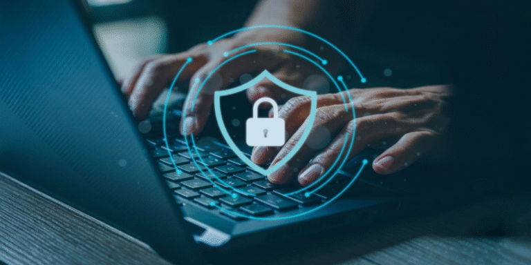 Hands typing on a laptop with a digital shield and padlock icon, representing cyber security awareness.